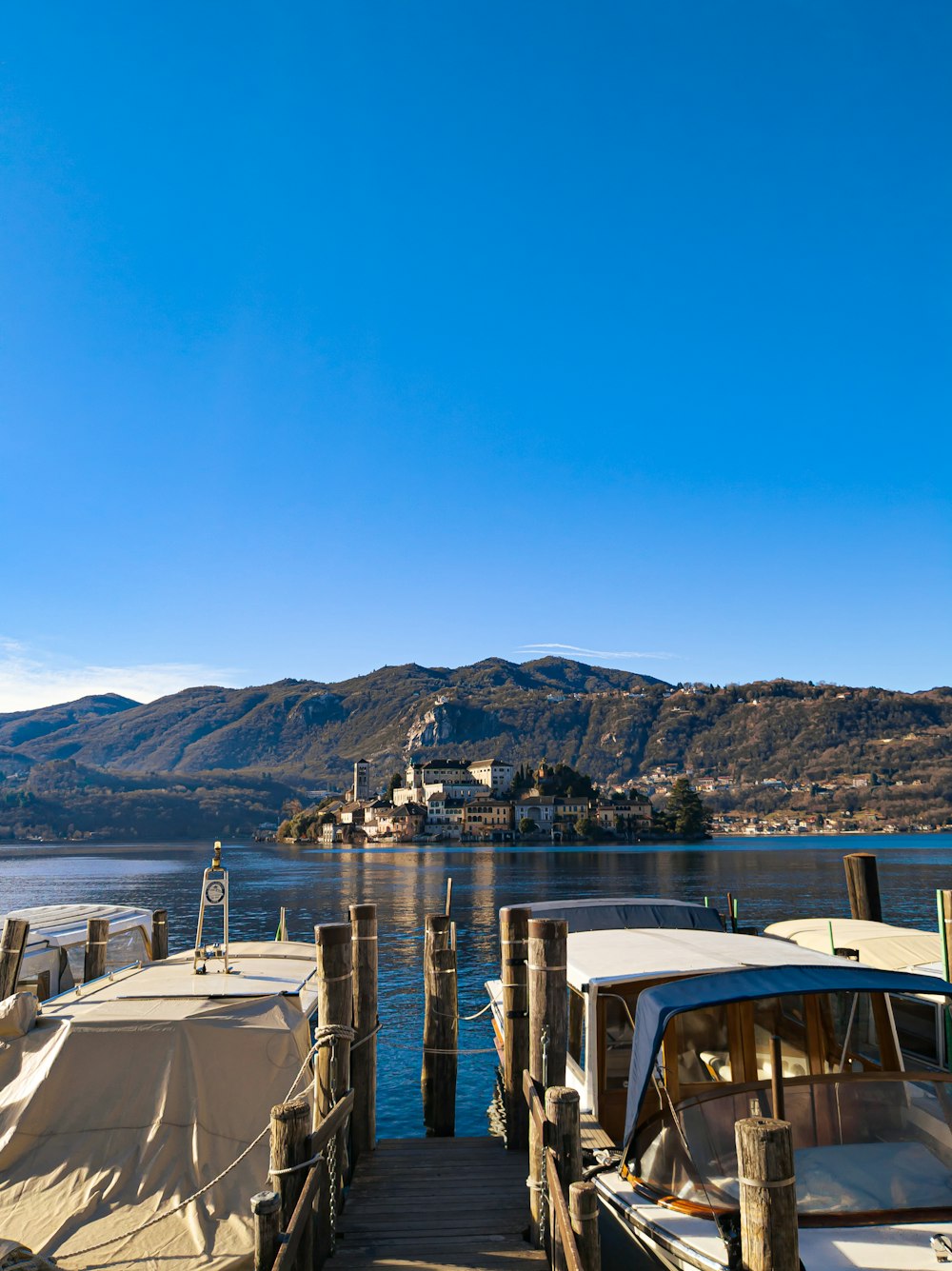 a boat dock with several boats tied up to it