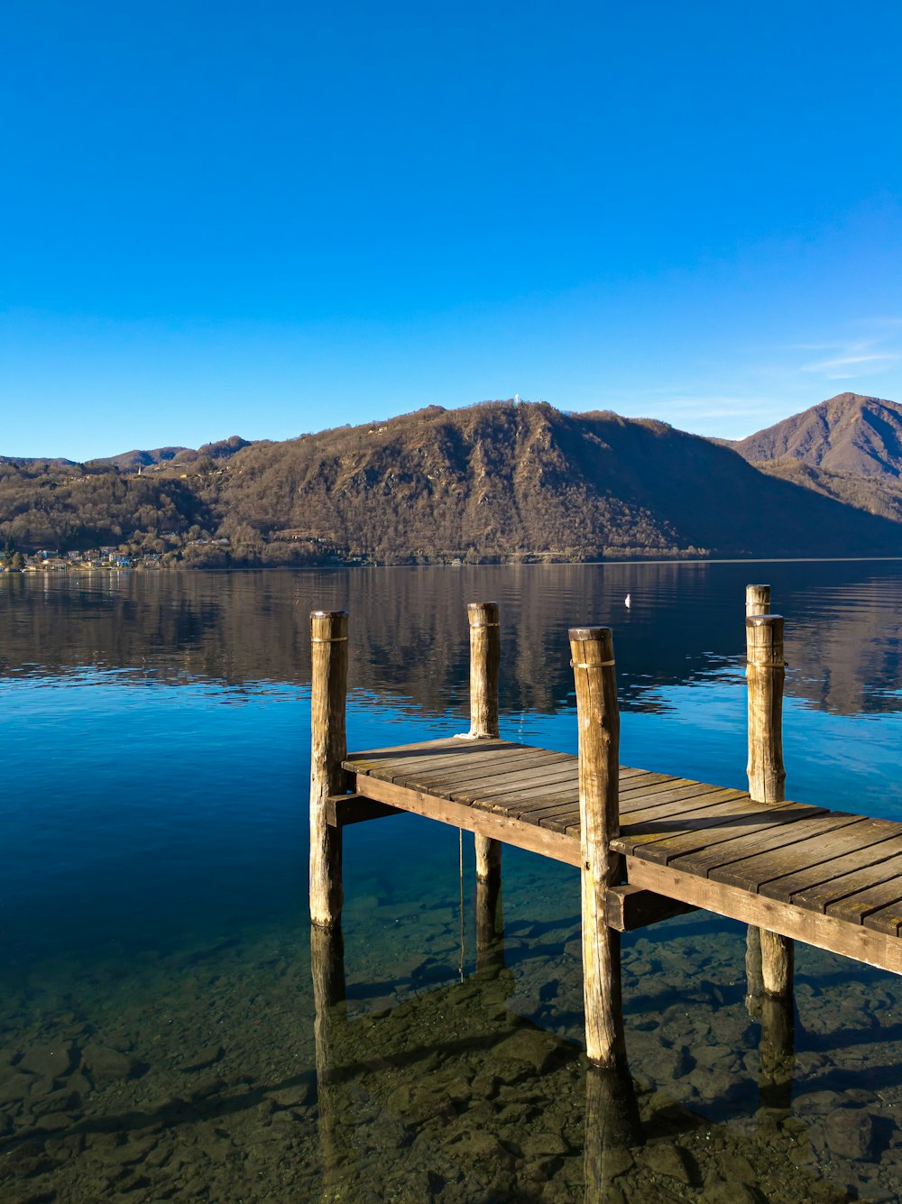 a wooden dock sitting in the middle of a lake