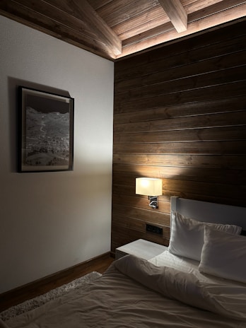 A cozy bedroom with a stylish hardwood floor design.