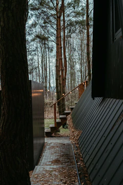 a walkway leading to a house in the woods