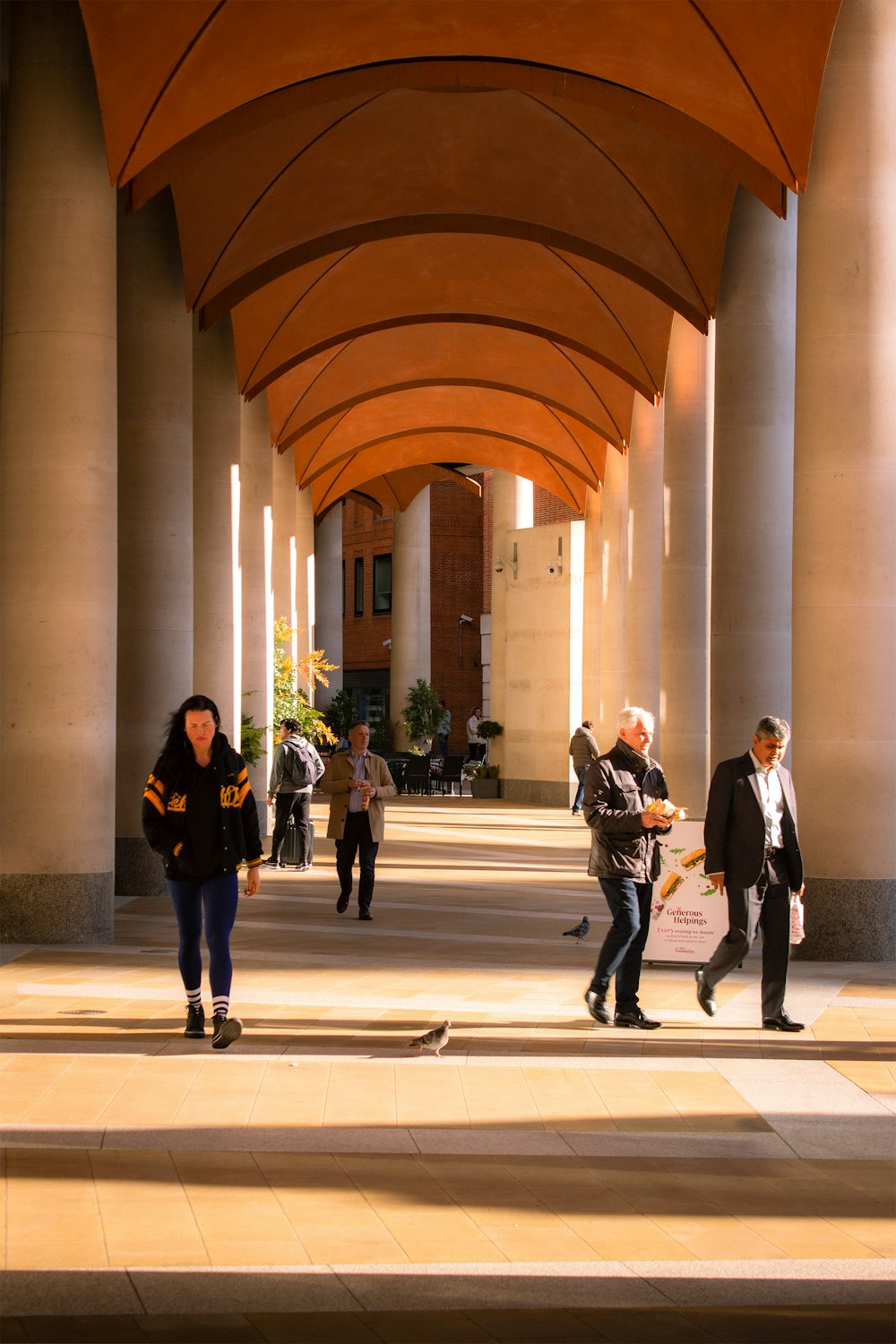 a group of people walking down a walkway