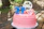 Festive birthday balloons and cake decorated with Oak City colors outdoors.