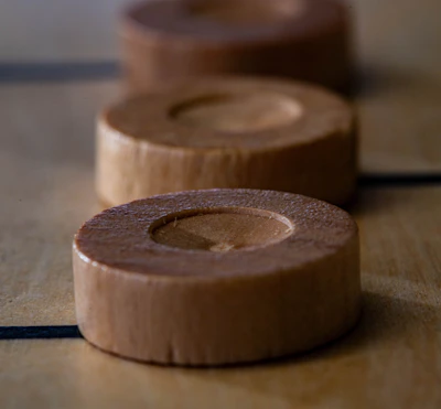 Close-up of hands gently resting on a wooden Sadhu board, highlighting texture and detail.
