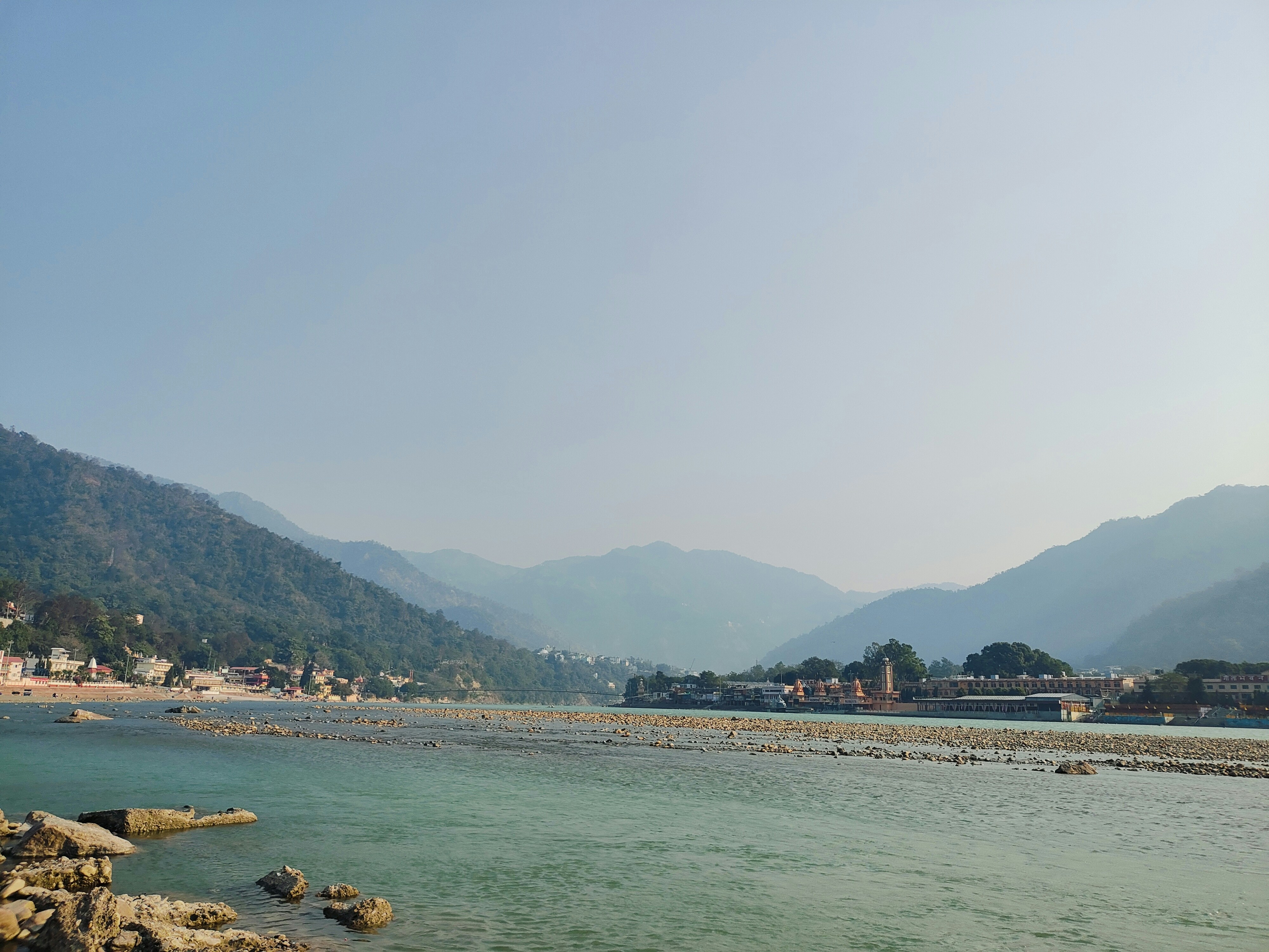 a body of water with mountains in the background