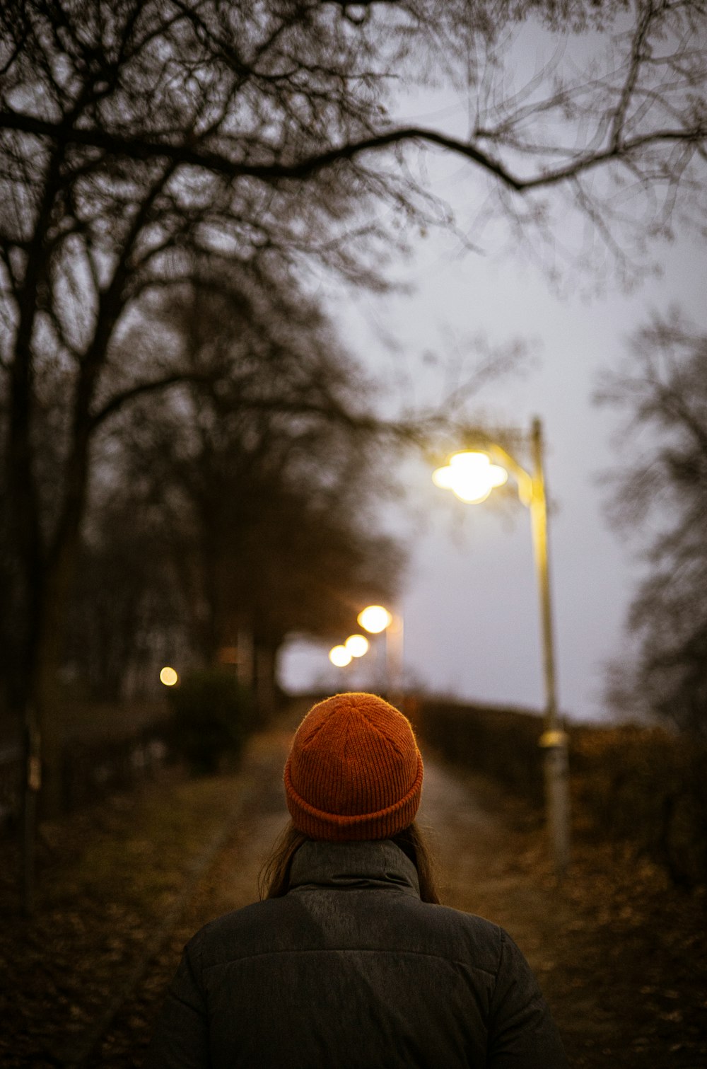 a person walking down a street at night