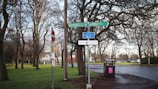 A close-up of a directional sign in a park.