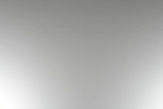 A close-up view of a plain, textured ceiling with a subtle off-white color.