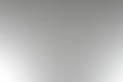 Before and after shot of a commercial interior wall, showing popcorn ceiling removal and fresh knockdown finish.