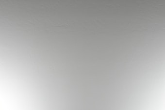 A close-up view of a plain, textured ceiling with a subtle off-white color.