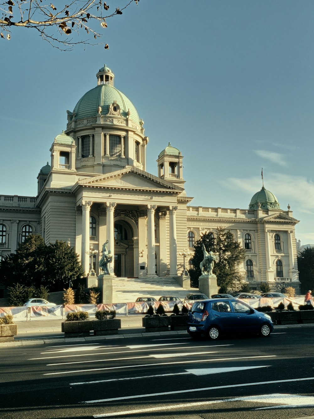 a car is parked in front of a large building