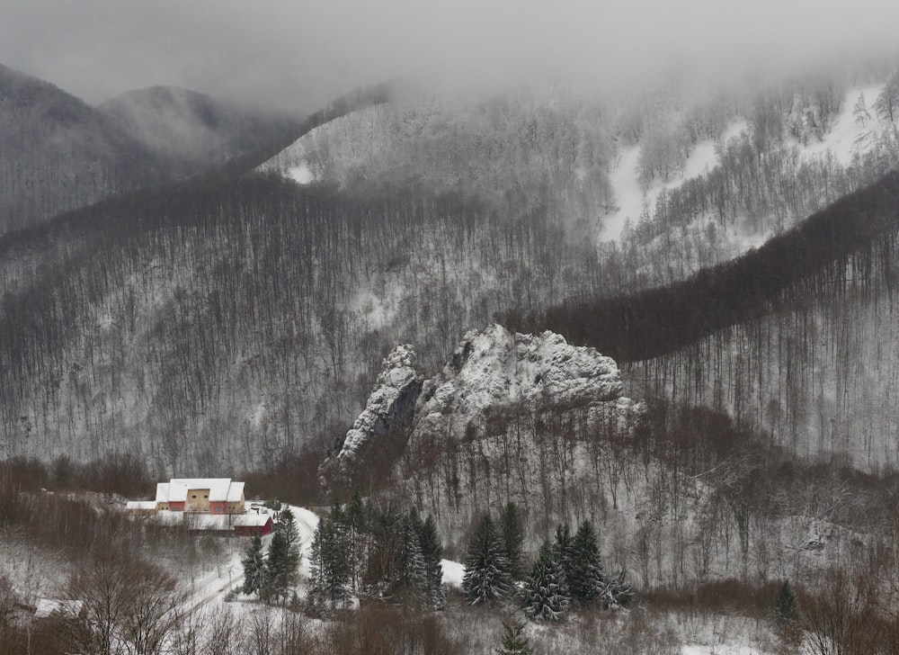 a snowy mountain with a house in the foreground