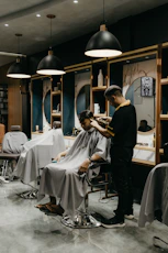 a man cutting another mans hair in a salon