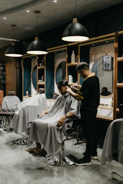 a man cutting another mans hair in a salon