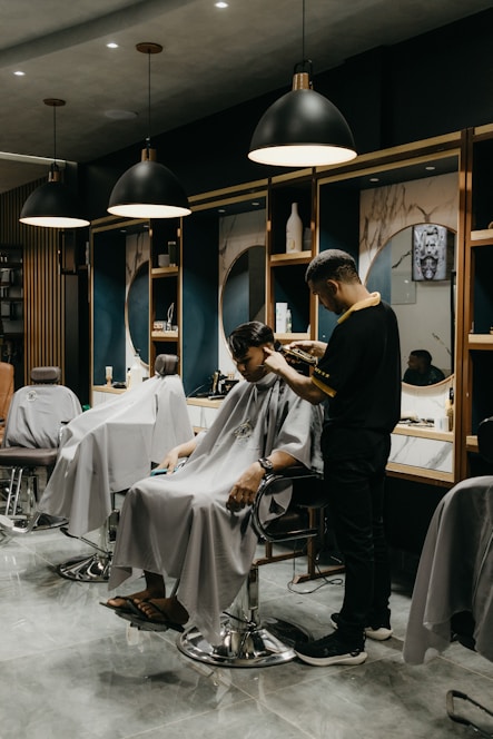 A stylish interior of Royal Barbershop showcasing modern barber stations.
