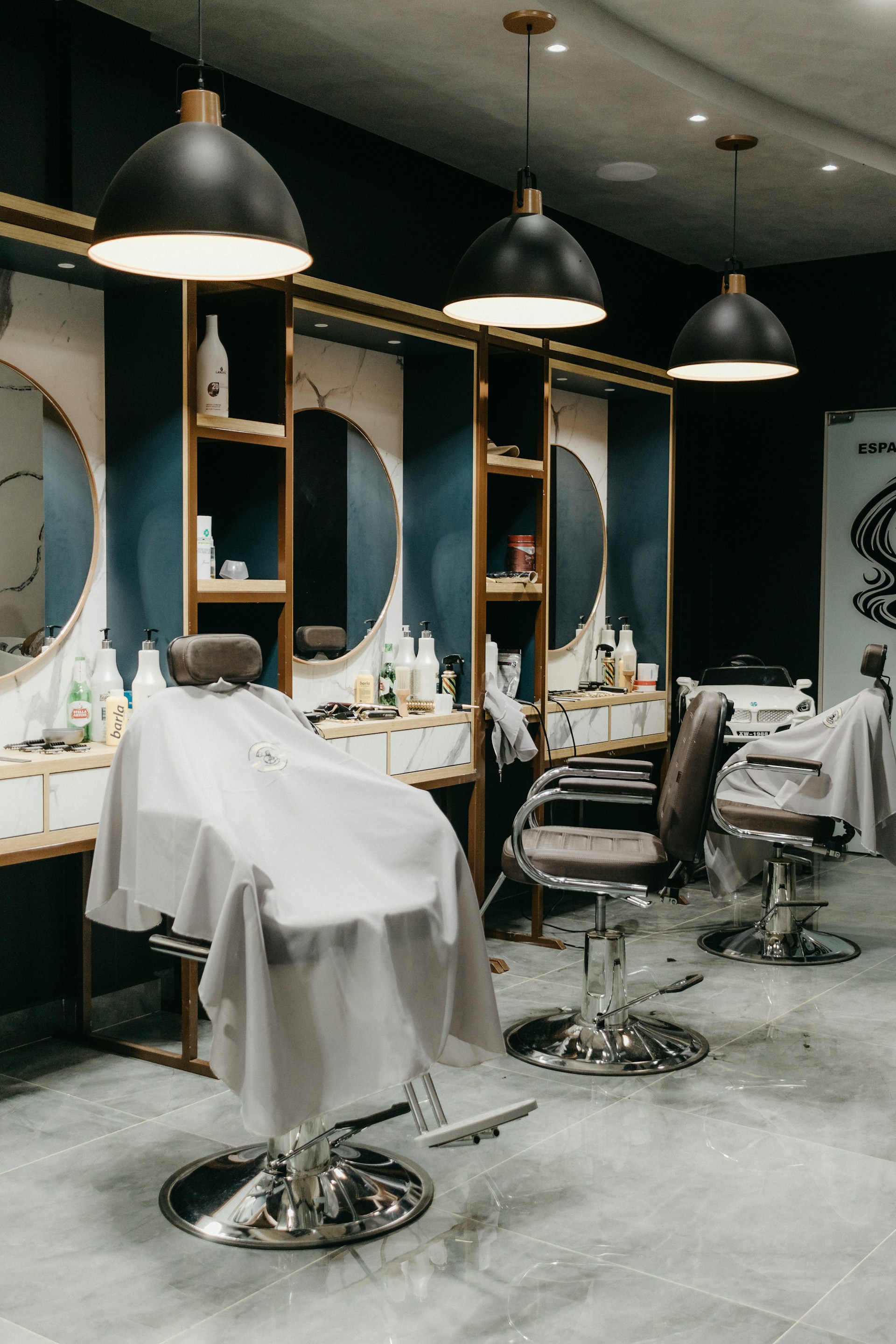 a hair salon with chairs and mirrors and lights