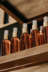 a shelf filled with bottles of different types of hair products