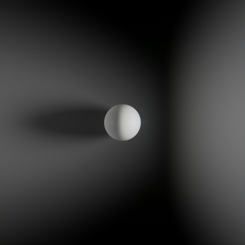 an image of a white ball in a dark room