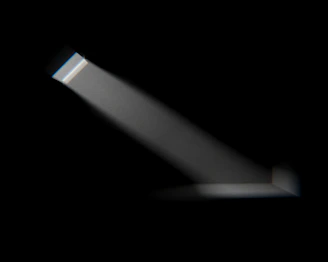 A striking 4K cinematic shot of a golden light beam cutting through a dark, smoky studio space.