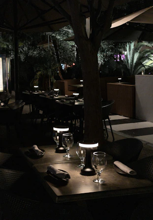 a dimly lit restaurant with tables and chairs