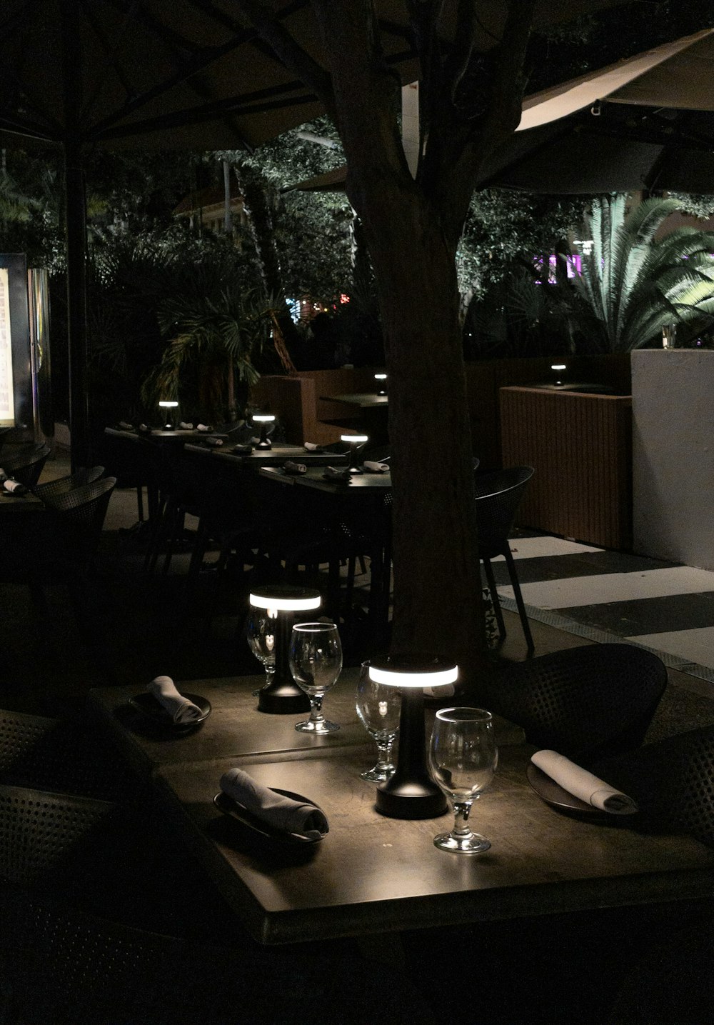 a dimly lit restaurant with tables and chairs