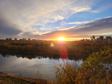 A vibrant sunset over downtown Naperville with the riverwalk bustling with visitors.
