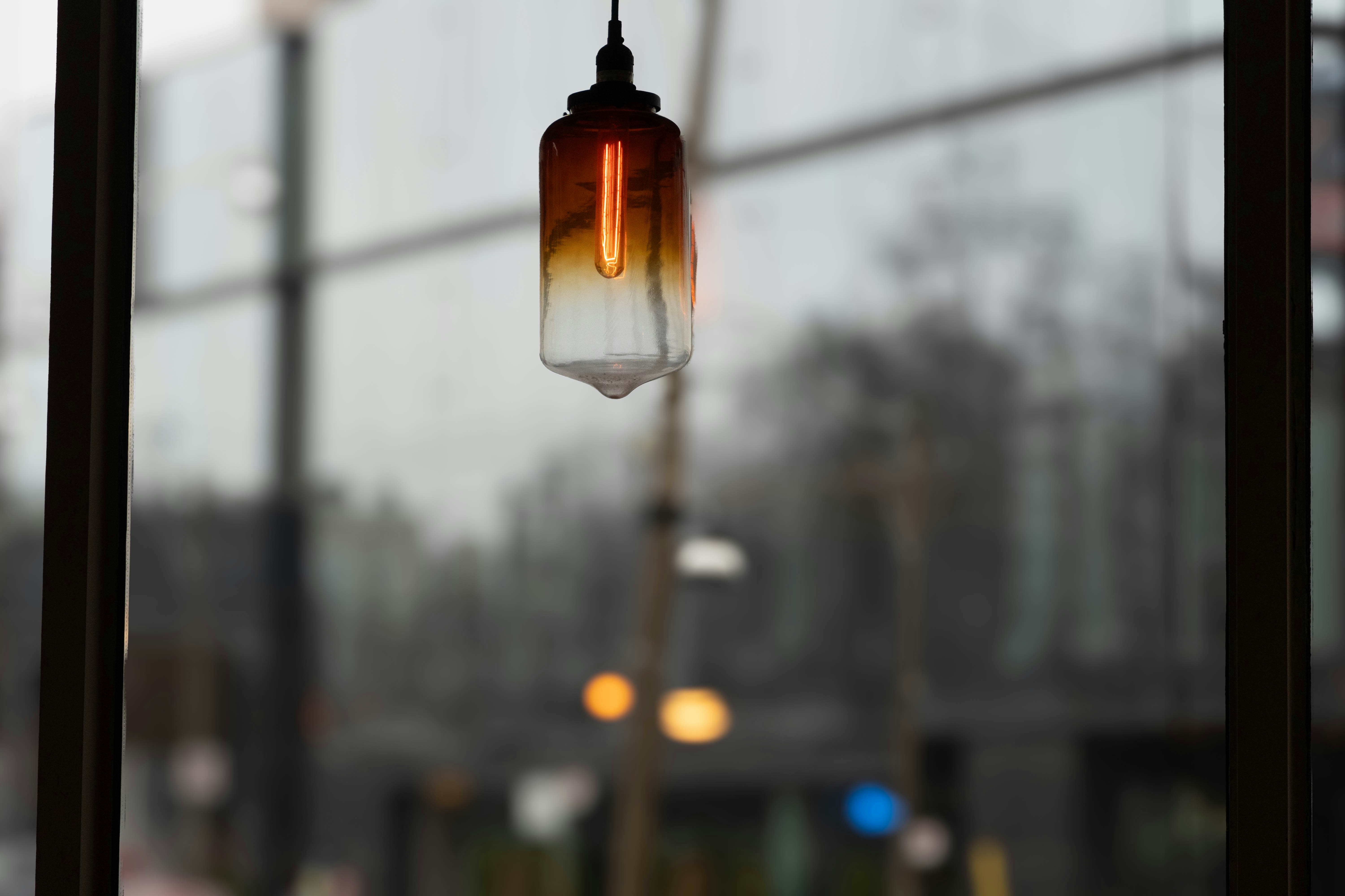 a light hanging from a window next to a street