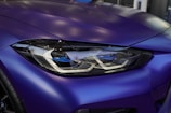 a close up of the front of a blue sports car