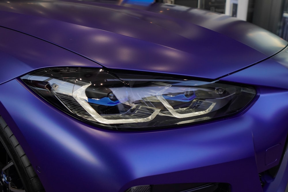 a close up of the front of a blue sports car