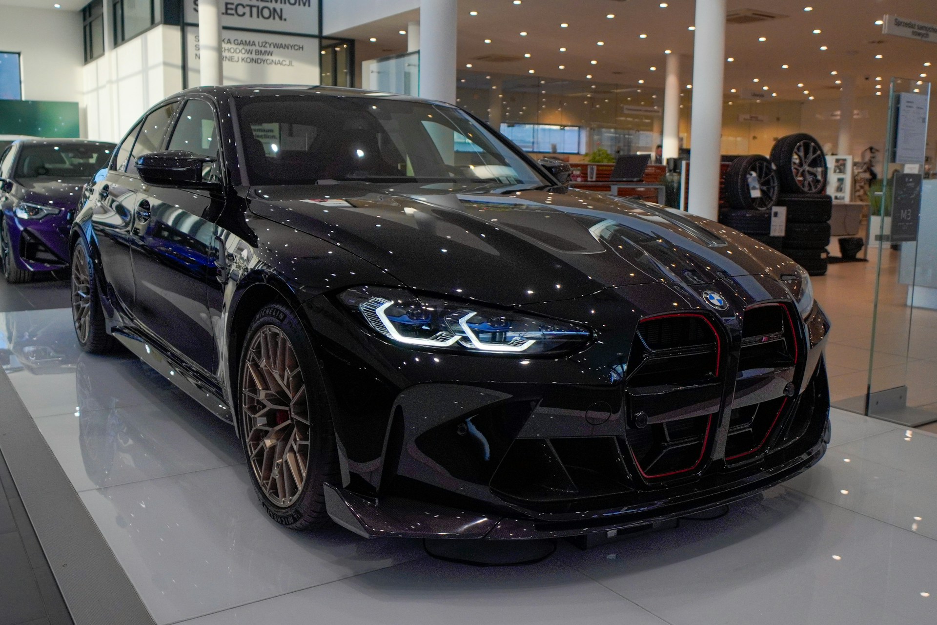 a black car is on display in a showroom