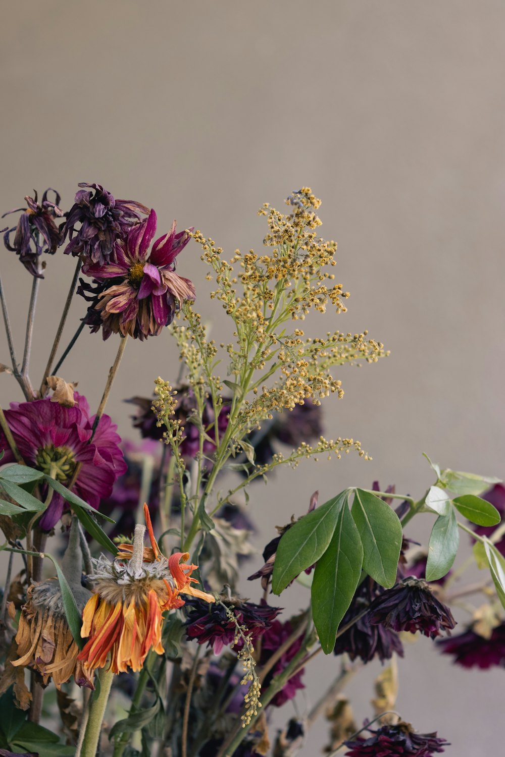 a vase filled with lots of different types of flowers