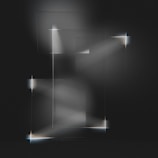 Geometric light patterns softly illuminating a workspace, creating a calm, focused cyber-minimal atmosphere.