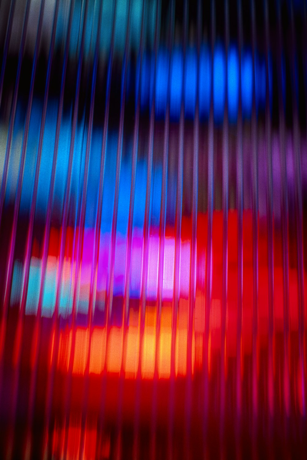 a blurry image of a red, blue, and pink object