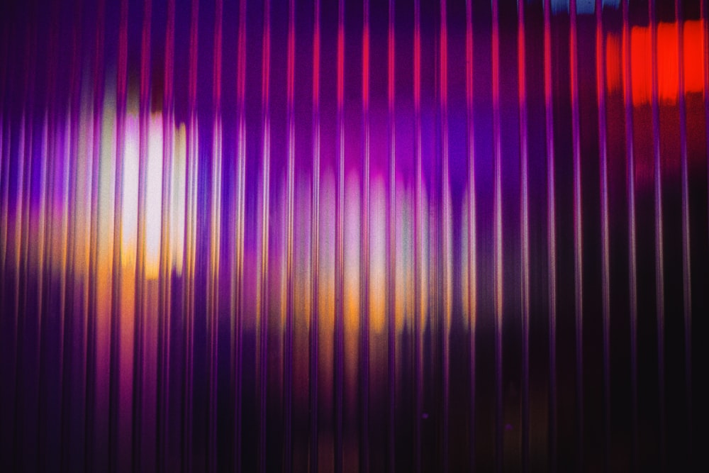 a purple and red background with vertical lines