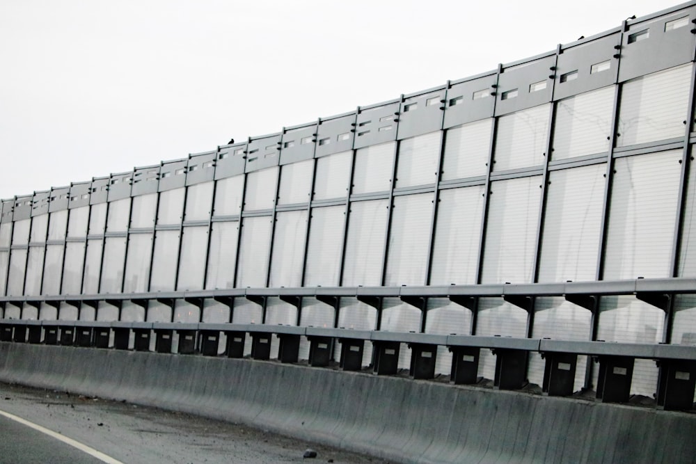 a large metal structure sitting on the side of a road