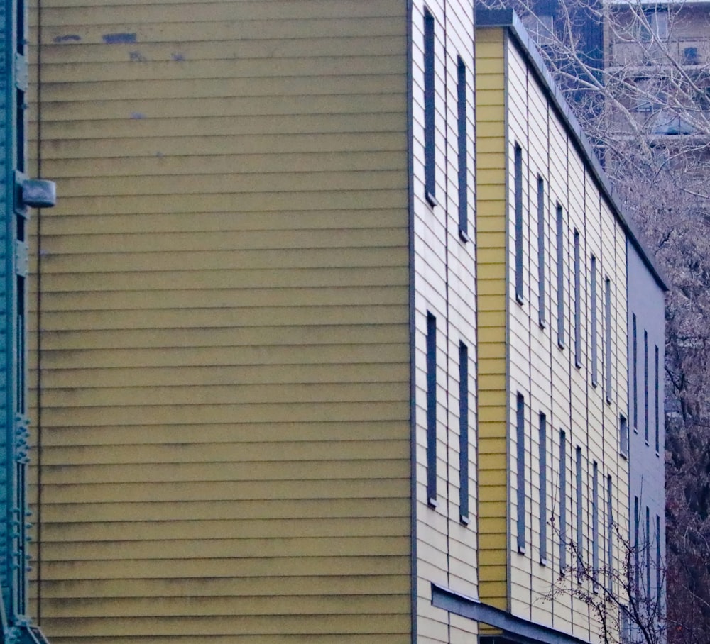 a yellow building with a clock on the side of it