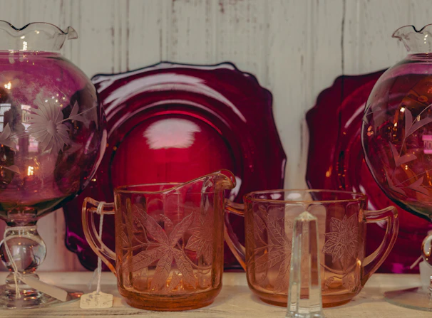 A set of laser-engraved glassware featuring delicate botanical illustrations.