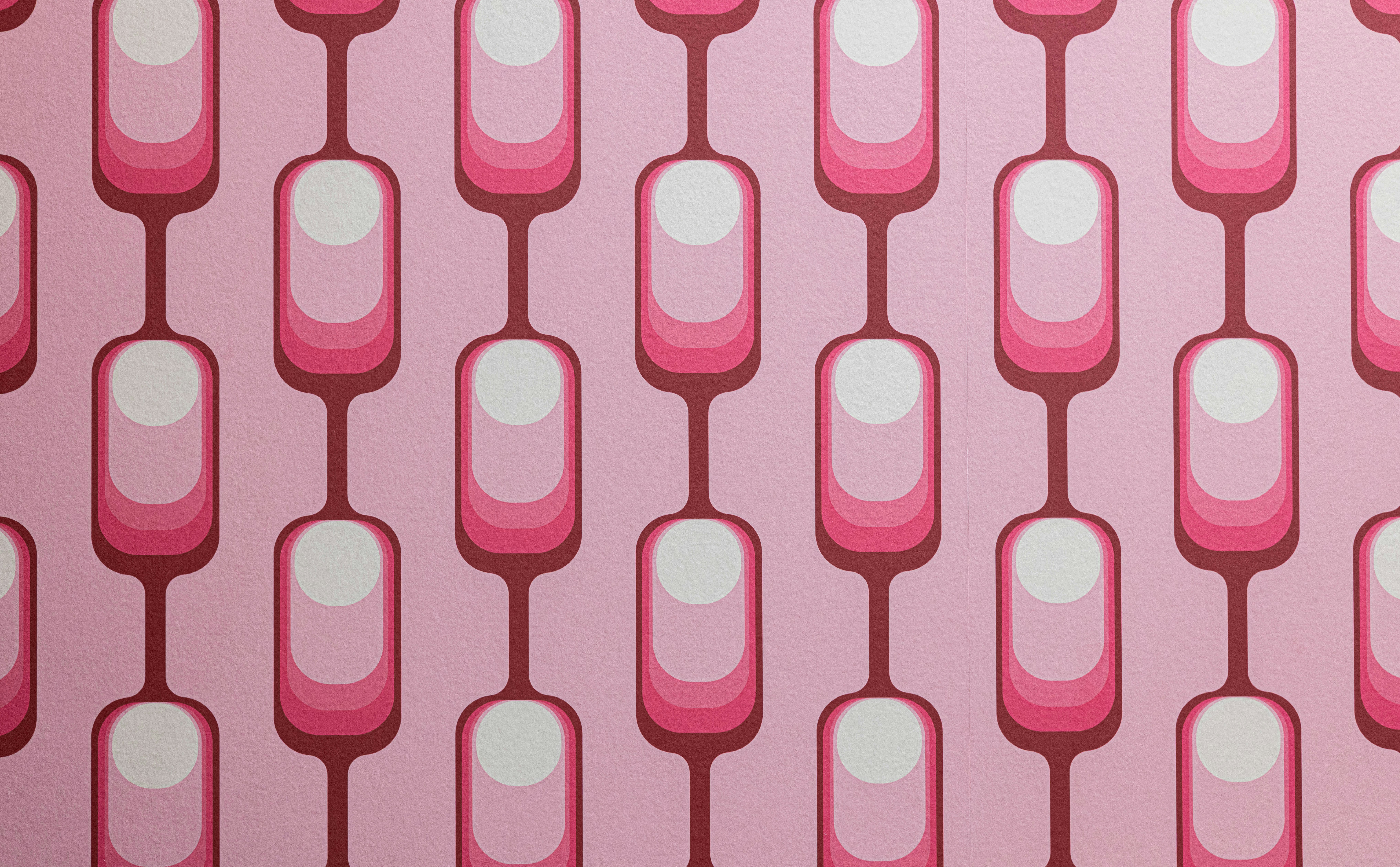 a pink and white wall with a pattern on it