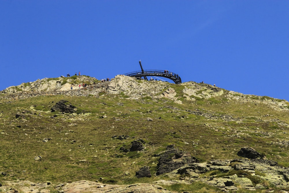 a cross on a hill with a blue sky in the background