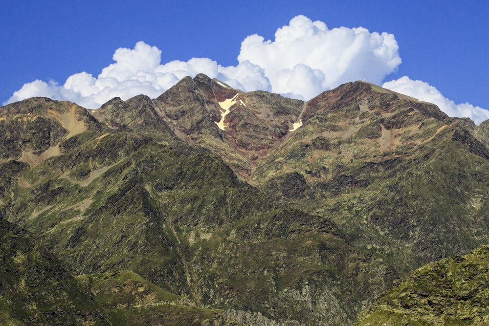 a view of a mountain range with clouds in the sky