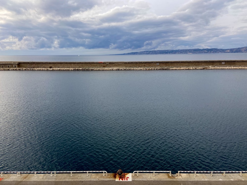 a large body of water with a sky background