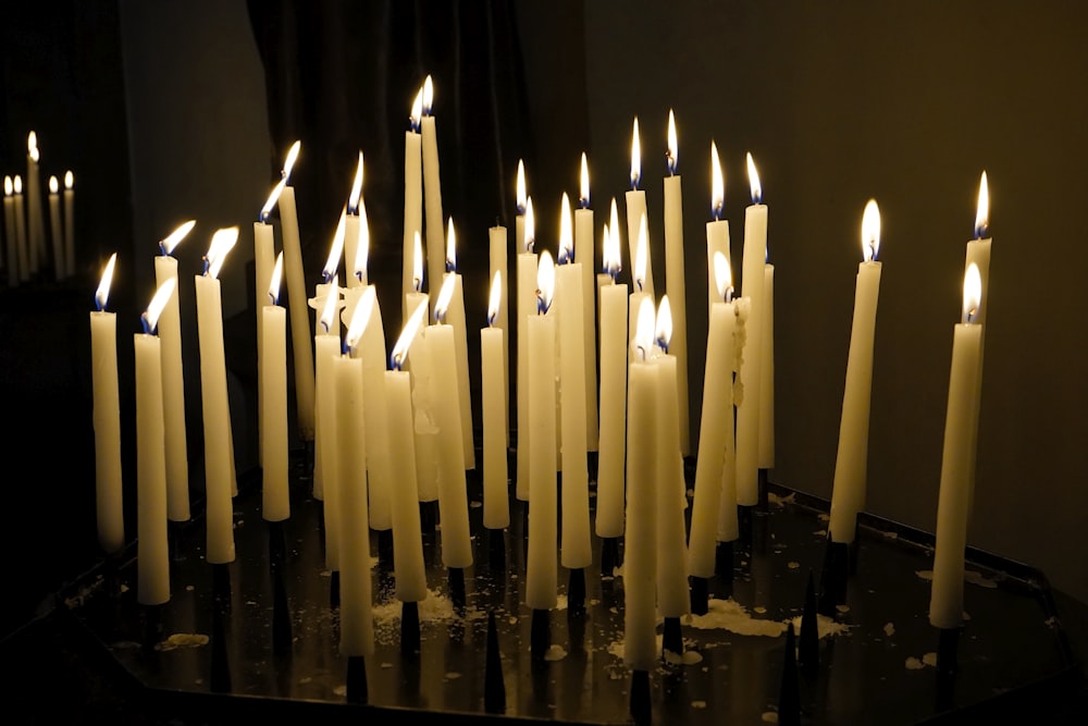 a group of lit candles sitting on top of a table