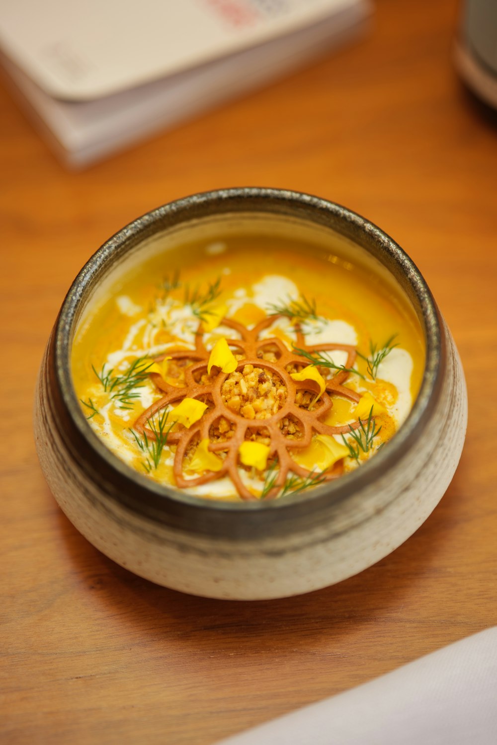 a bowl of soup on a wooden table