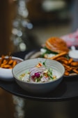 A traditional bowl of ceviche garnished with cilantro.