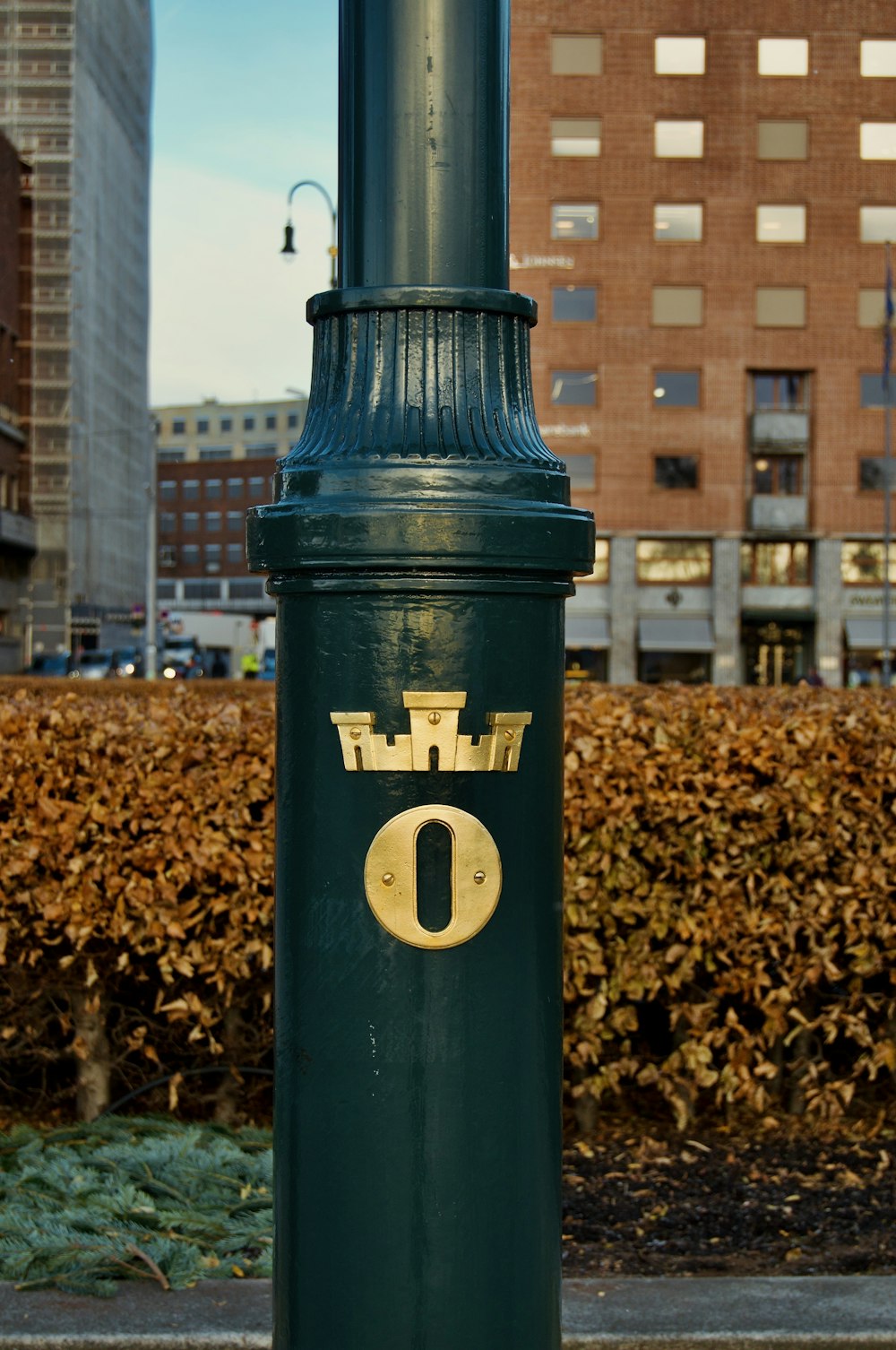 a close up of a green pole with a number on it