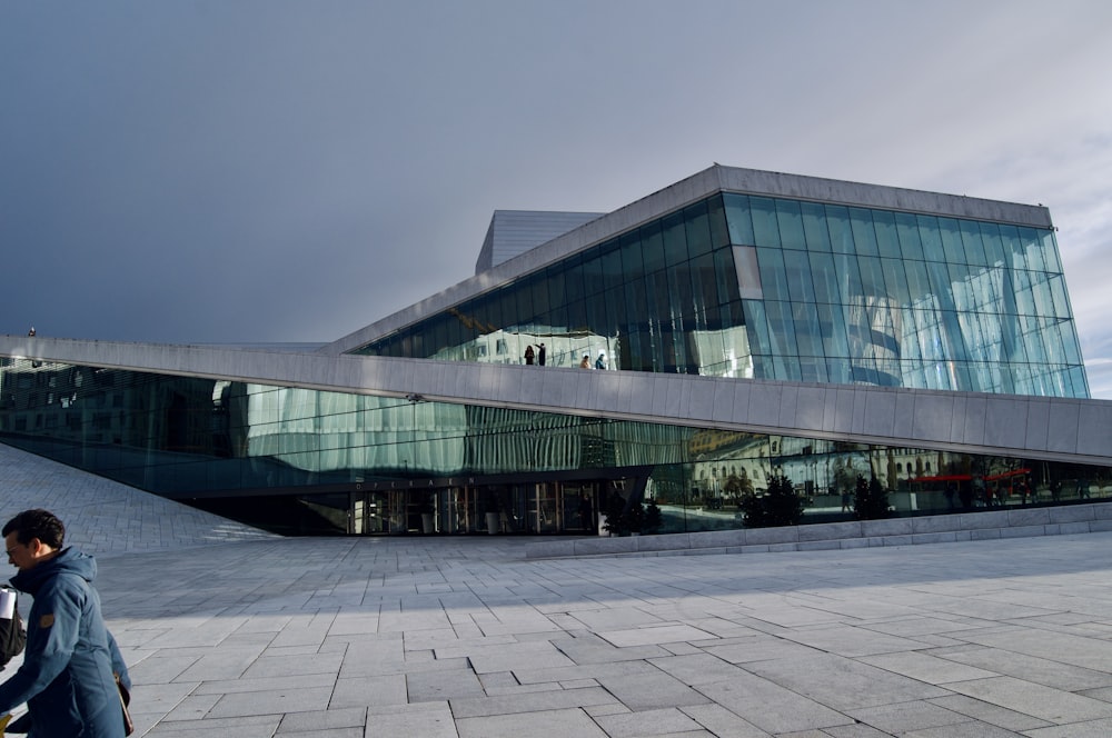 a person walking in front of a large building