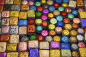 Close-up of colorful silicone nameplates and ornaments neatly arranged on a factory table.