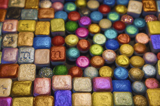 Close-up of colorful silicone nameplates and ornaments neatly arranged on a factory table.