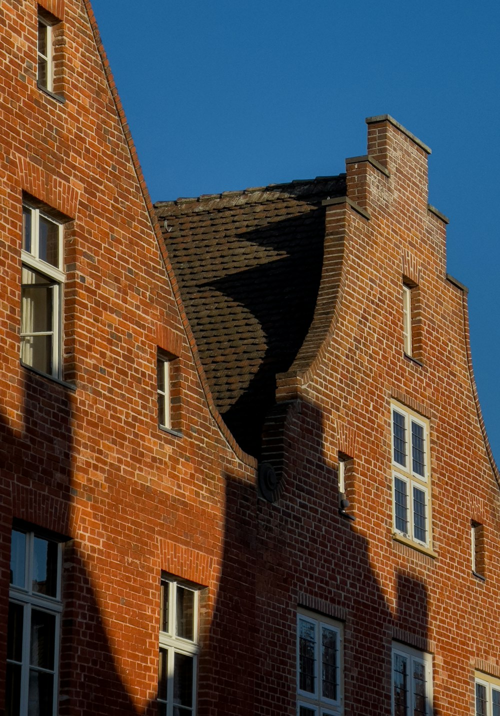 a red brick building with a clock on the front of it