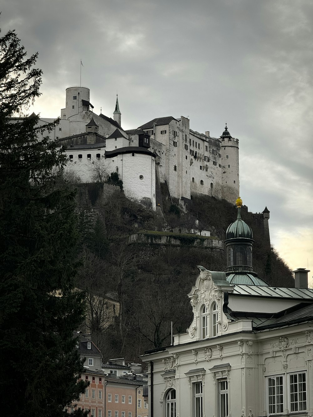 a castle on top of a hill with a clock tower