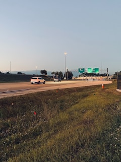 A clear view of traffic signs along a highway at sunset.